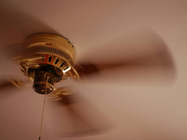 istock Ceiling fan. Creating air coolness on hot days. Dramatic cinematic atmosphere. Copyspace. Space for titles or text 1959935517