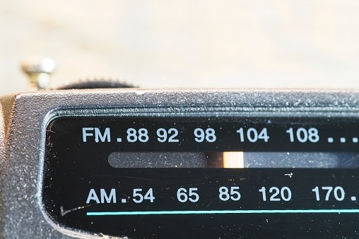 Analog AM FM radio tuning dial with some dust and scratches