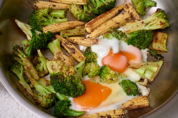 Roasted green grilled vegetables in plate on stainless background. Top view, flat lay shooting. Close-up view of a barbecued healthy food.