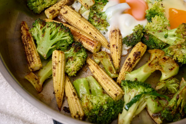Roasted green grilled vegetables in plate on stainless background. Top view, flat lay shooting. Close-up view of a barbecued healthy food.