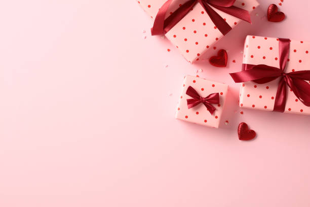 istock Valentine's Day holiday background with pink gift boxes decorated red ribbon bow, red hearts. Flat lay, top view. Love, romance concept. 1959977458