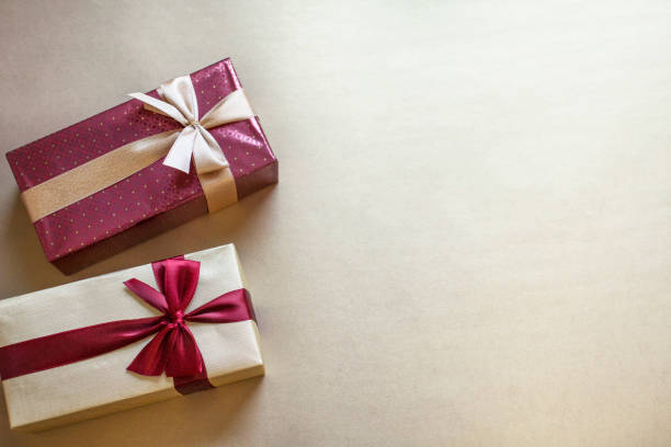 istock Christmas and Valentines Day composition, top view of two gift boxes on gold background 1959983273