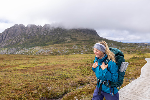 Venturing into the heart of Tasmania's untamed beauty, a young woman embarks on an immersive journey along a long-distance trail. Her solitary footsteps echo through the pristine wilderness, as towering trees and rugged landscapes become witnesses to her odyssey. With a determined spirit, she navigates the meandering path, embracing the solitude and serenity that only the vast Tasmanian wilderness can provide. The air is crisp, the scenery awe-inspiring, as each step becomes a testament to her resilience and the profound connection between the intrepid traveler and the untouched wonders of nature.