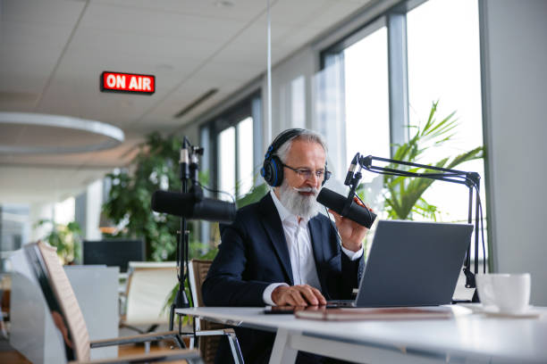 istock Corporate Podcast Host with Gray Hair and Beard 1959997373