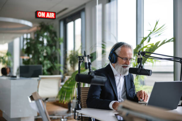 istock Gray-Haired Senior Professional Recording Podcast 1959997375
