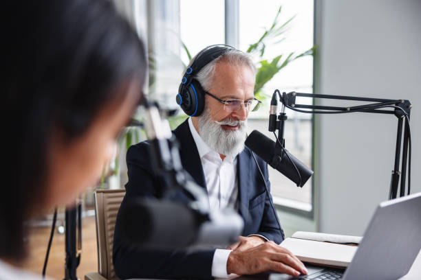 istock Gray-Bearded Senior Male in Podcast Production 1959997379
