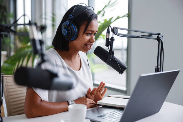 istock Happy Podcast Host in Professional Recording Studio 1959997392