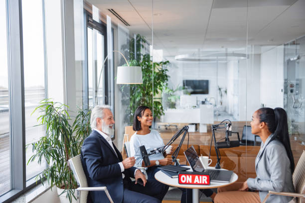 istock Multicultural Podcast Discussion in Contemporary Office 1959997905