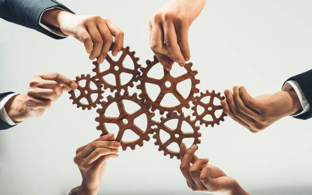 istock Business team joining cogwheel in circular together. Shrewd 1960021971