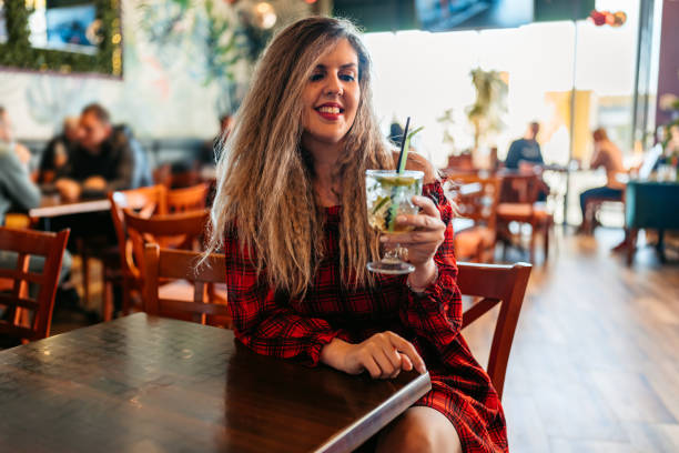 istock Young Woman Drinking Mojito Cocktail In A Bar 1960025565