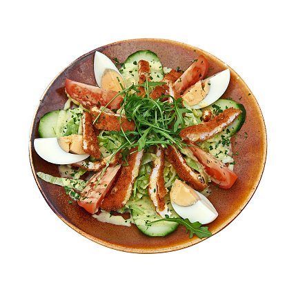 Plate of chicken in salad with lettuce view from above and isolated with clipping path