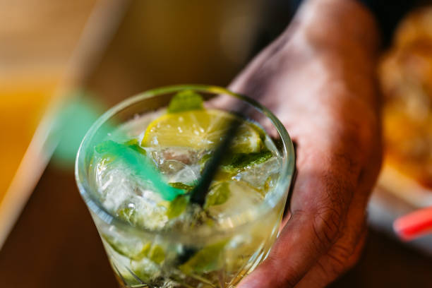 istock Young Man Drinking Mojito Cocktail In A Bar 1960032491