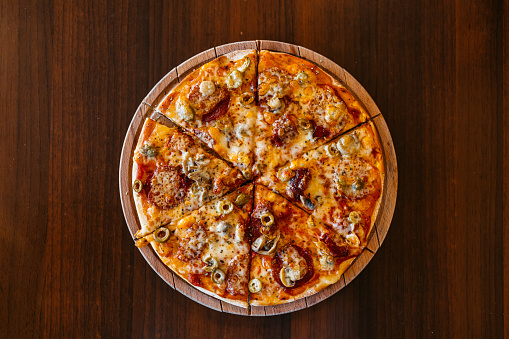 Sliced pizza on the table in a pub.