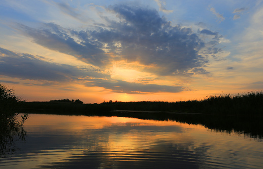 Nice sunset sky over lake water surface