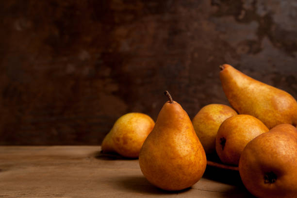istock Pears on wooden background as background image. 1960095988