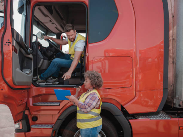 female transportation manager and male truck driver going through checklist - truck driver multi ethnic group industry working class fotografías e imágenes de stock