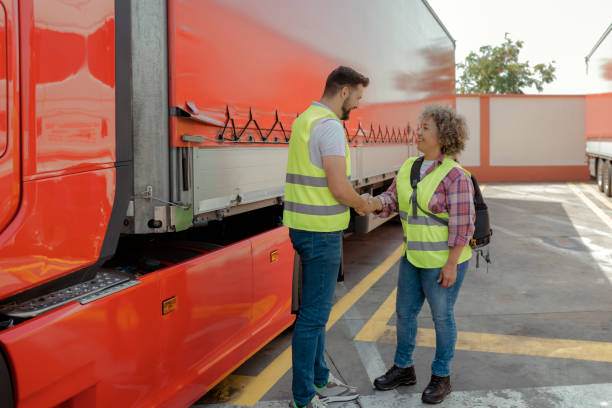 istock Truck Drivers Shaking Hands on Parking Lot 1960105002