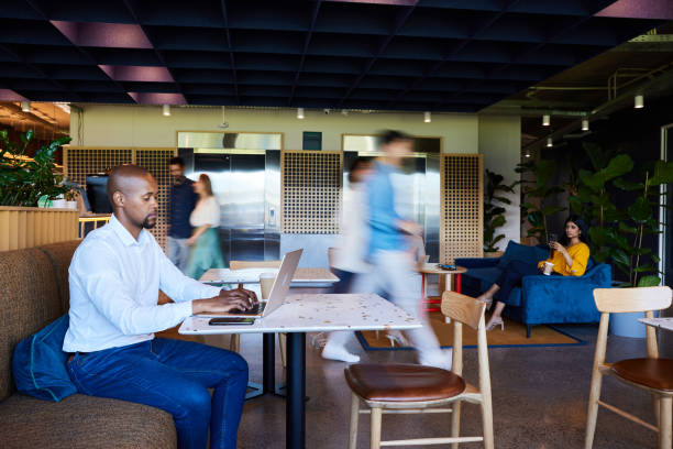 istock Businesspeople working with colleagues walking in blurred motion in an office 1960117622