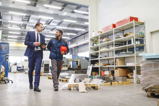 istock Sophisticated Caucasian Male Manager Giving Instructions To A Warehouse Worker While Strolling Around The Warehouse 1960125849