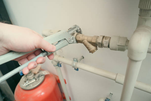 istock Plumber at work, plumbing repair service, assemble and install concept. Plumber fixing central heating system 1960145042