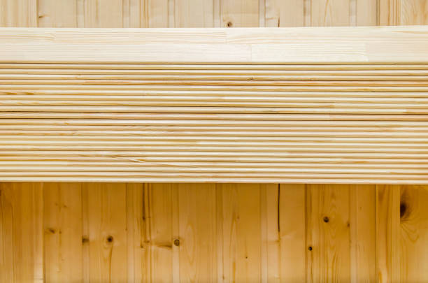 stack of thin sanded boards neatly laid in a row on the counter in a hardware store