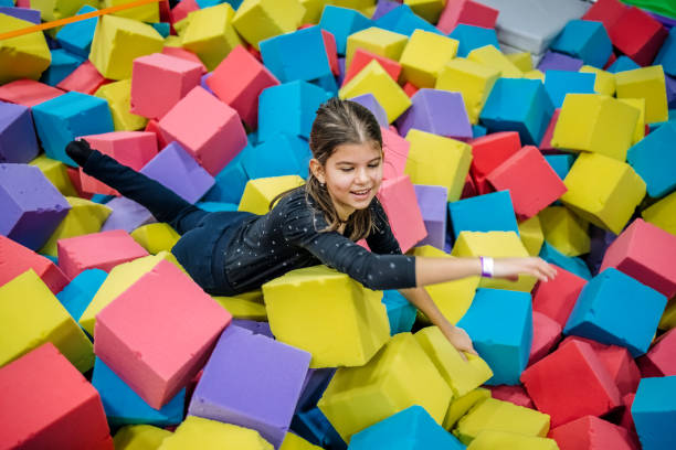istock Kids having fun at indoor playground playing in pool full with sponge bricks 1960164338