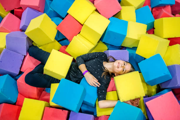 istock Kids having fun at indoor playground playing in pool full with sponge bricks 1960164861
