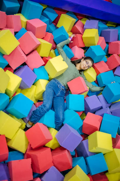 istock Kids having fun at indoor playground playing in pool full with sponge bricks 1960164869