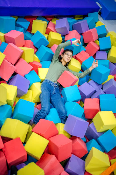 istock Kids having fun at indoor playground playing in pool full with sponge bricks 1960164873