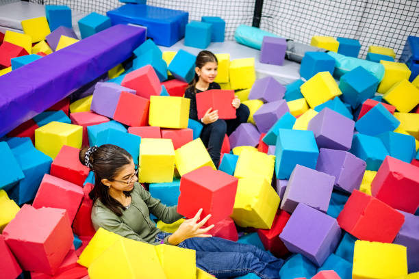 istock Kids having fun at indoor playground playing in pool full with sponge bricks 1960165999
