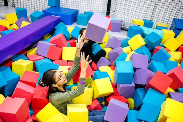 istock Kids having fun at indoor playground playing in pool full with sponge bricks 1960166005