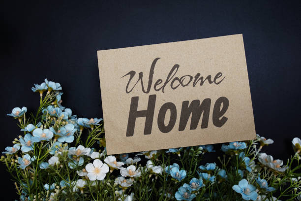 Welcome Home text message with flower decoration on black background