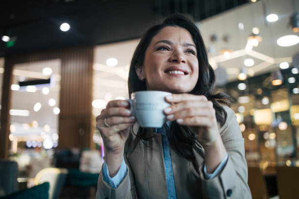 istock Young woman drinking coffee in a coffee shop 1960175831