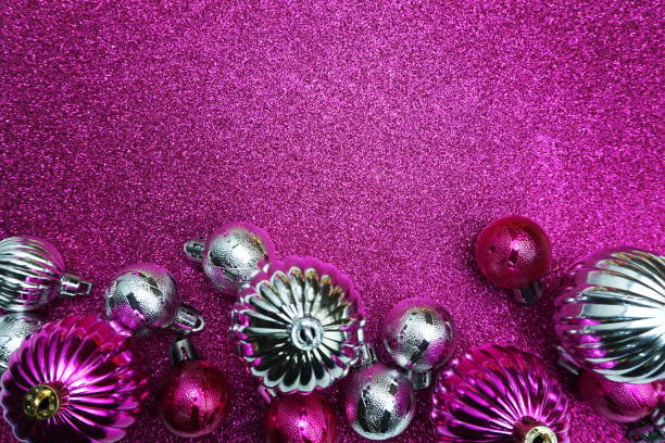 Christmas balls composition decoration ornaments with space copy on pink glitter background