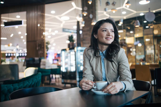 istock Young woman drinking coffee in a coffee shop 1960176929
