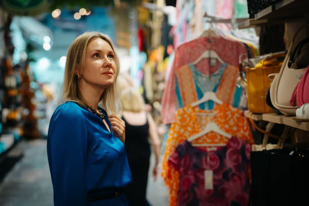 istock Woman choosing a bag at the evening bazaar. 1960181251