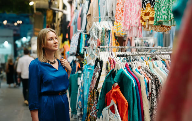 istock Woman choosing a clothes at the evening bazaar. 1960181260