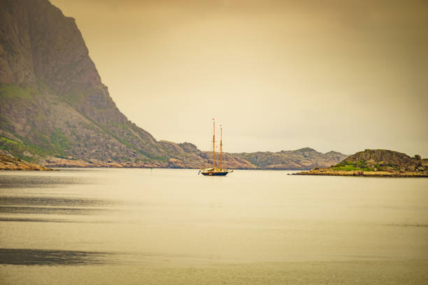 Sailing ship on water sea, norwegian fjord nature. Cruising, travel by sailboat, vacation trip for pleasure. Lofoten Norway