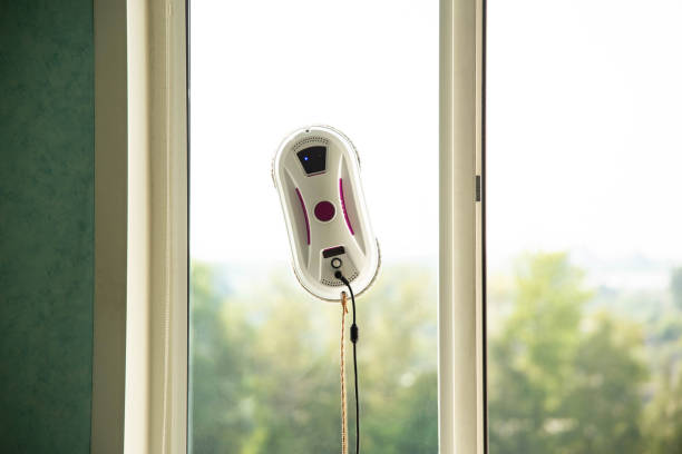 istock Vacuum automatic robot window cleaner cleans glass from dirt without human intervention and the risk of falling from a height. Window cleaning safety is top notch. Copy space for text 1960206877