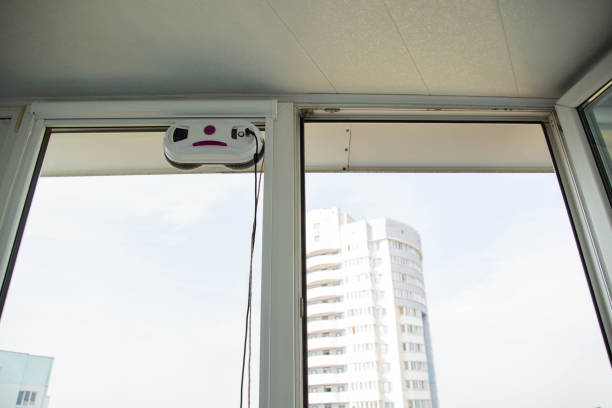 istock Automatic vacuum robot window cleaner washes glass in the apartment, balcony frame, 1960206883