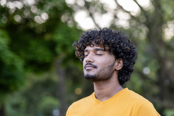 istock Focused indian sportsman doing breathing exercise in a peaceful park setting 1960217431