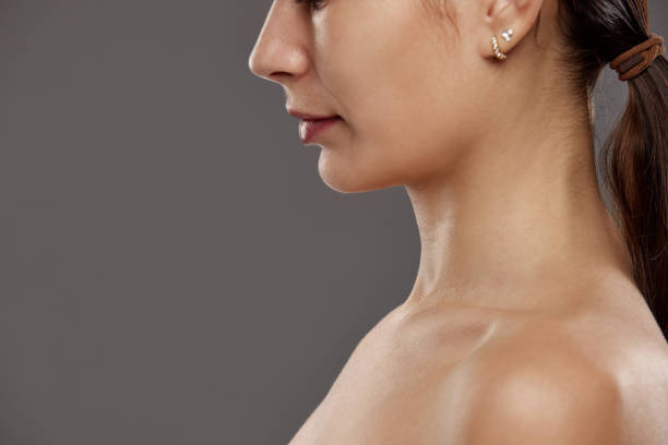 istock Double chin. Cropped image of female face, profile against studio background. Face lifting, massage, plastic surgery. 1960234363