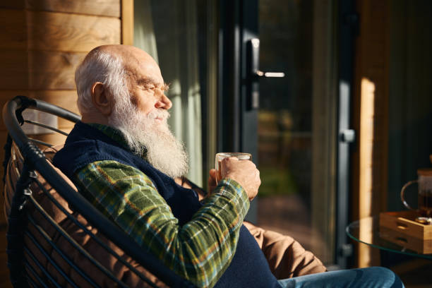 istock Elderly man is sitting on veranda with cup of tea 1960250858