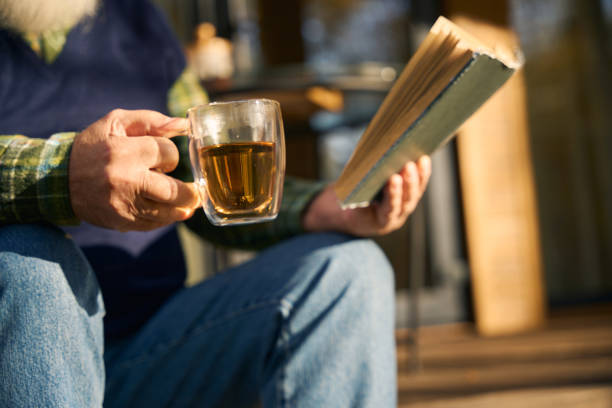 person holding and giving a book, share a present and knowledge