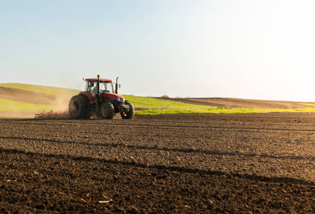 istock Farmer in tractor preparing land for sowing 1960263327