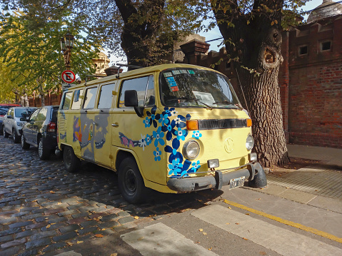 Buenos Aires, Argentina - May 13, 2023: Old flower paint 1970s Volkswagen Type 2 T2 Transporter Kombi minibus parked in the street