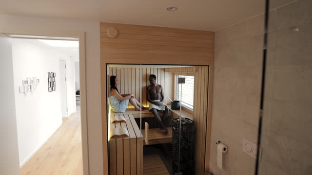Couple Relaxing in a Home Finnish Sauna