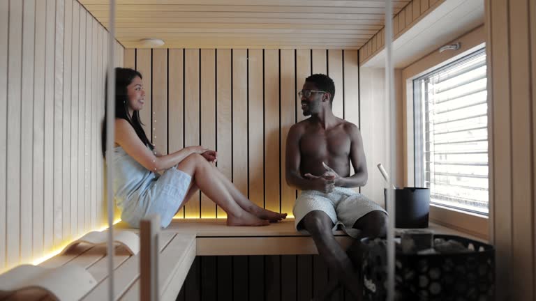 Couple Relaxing in Home Sauna, Engaging in Conversation