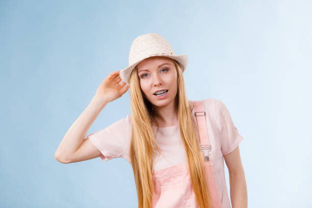 Close-Up Of Smiling Young Woman Covering Eyes With Knit Hat