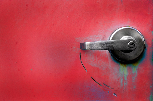 Red industrial doors textured metal door with handles for opening and locks for security